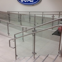 S/S ramp and stair rails with glass panels at a local FORD Dealership